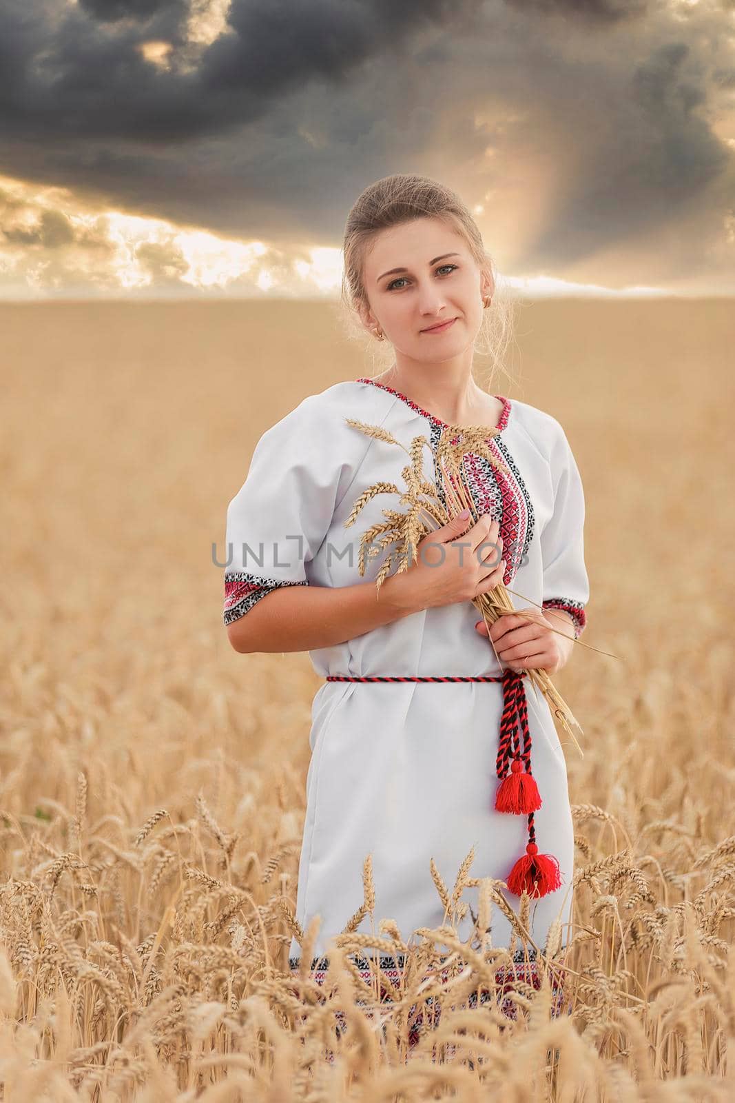 girl in Ukrainian national costume on a wheat field by zokov