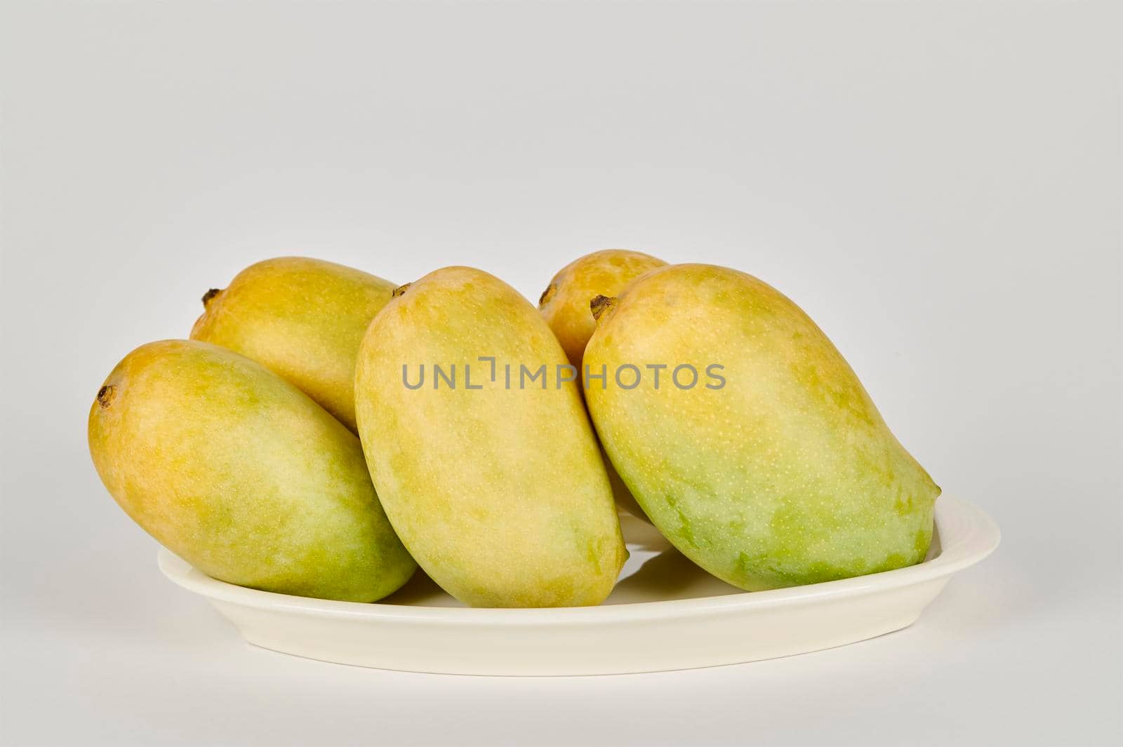 Plate of Kesar Mangoes on a white background