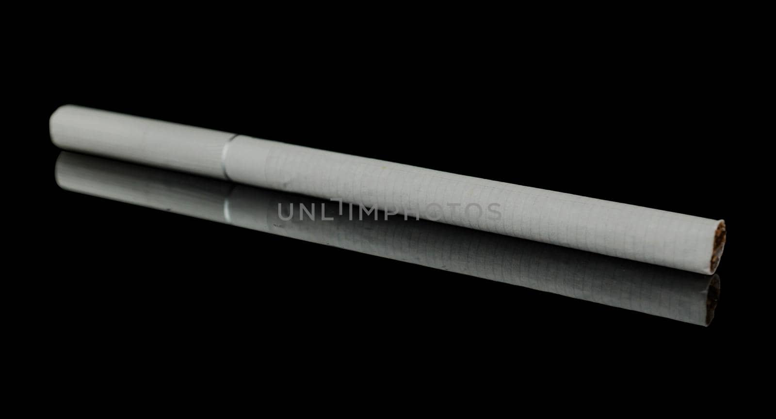 One thin cigarette on a black background, with reflection