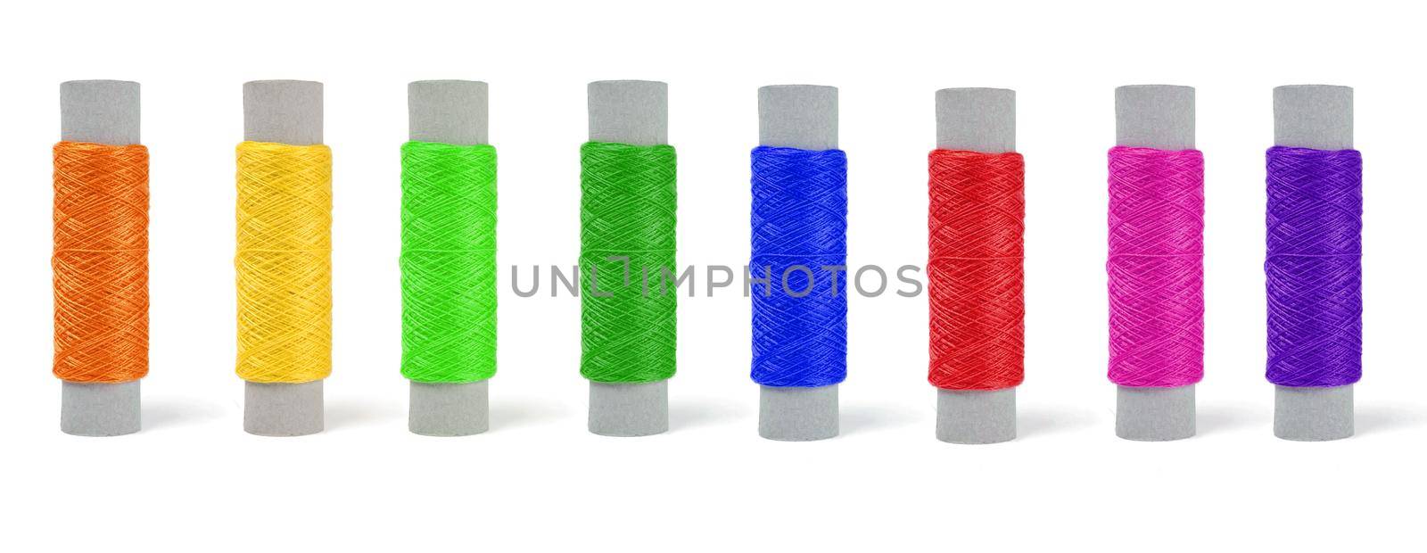 skeins of thread of different colors, set in a row on a white background