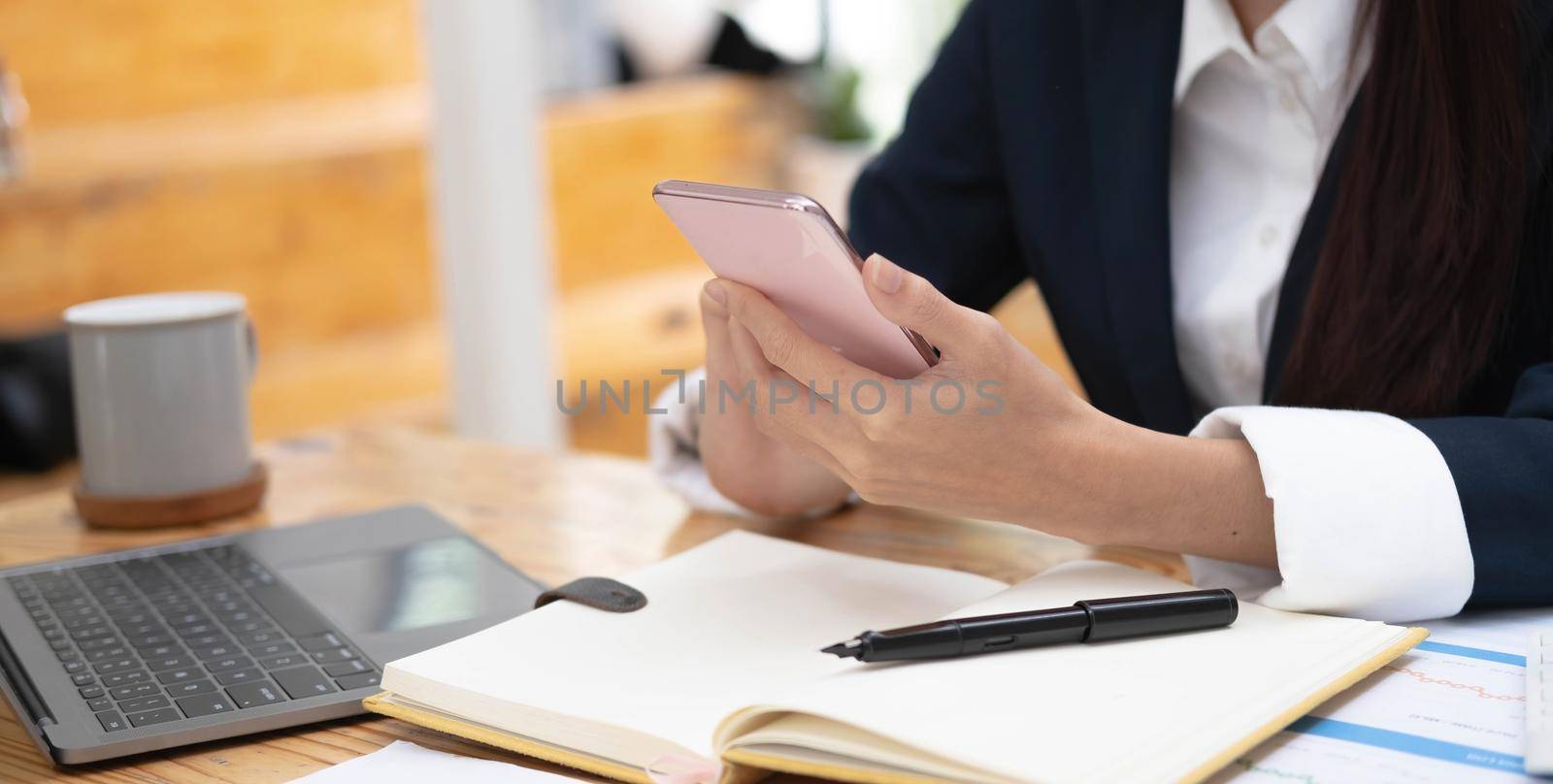 Crop close up of female look at smartphone screen browse surf wireless internet on modern gadget. Young Caucasian woman hold use cellphone device text or message online on cell. by wichayada