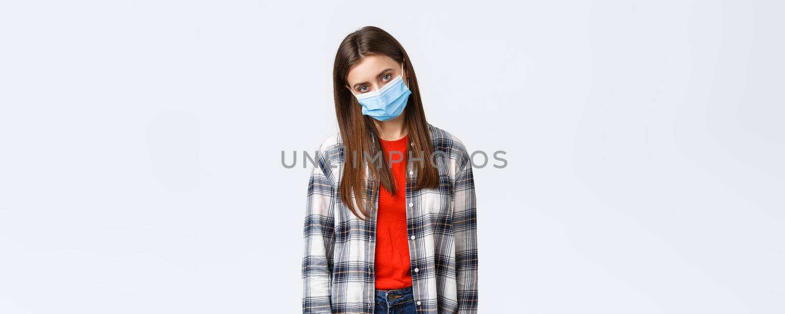 Coronavirus outbreak, leisure on quarantine, social distancing and emotions concept. Tired and bored young woman in medical mask complaining staying home self-isolation, want party and have fun.