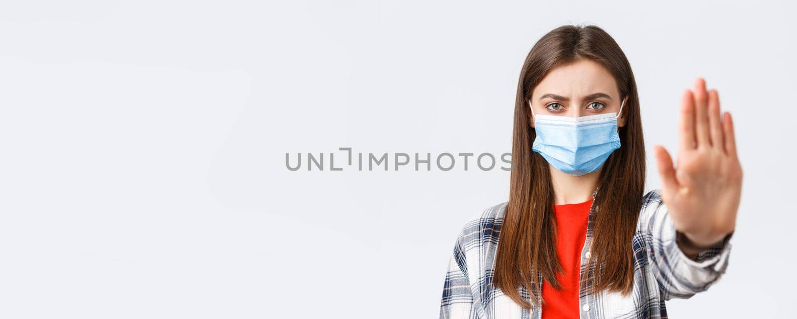 Coronavirus outbreak, leisure on quarantine, social distancing and emotions concept. Close-up of serious determined young woman want prevent or stop smth, stretch hand in restriction or warning.