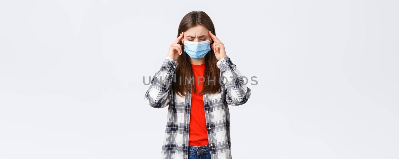 Coronavirus outbreak, leisure on quarantine, social distancing and emotions concept. Woman trying concentrate, thinking, close eyes rub temples, have fever covid-19 symptom, feeling dizzy or sick.