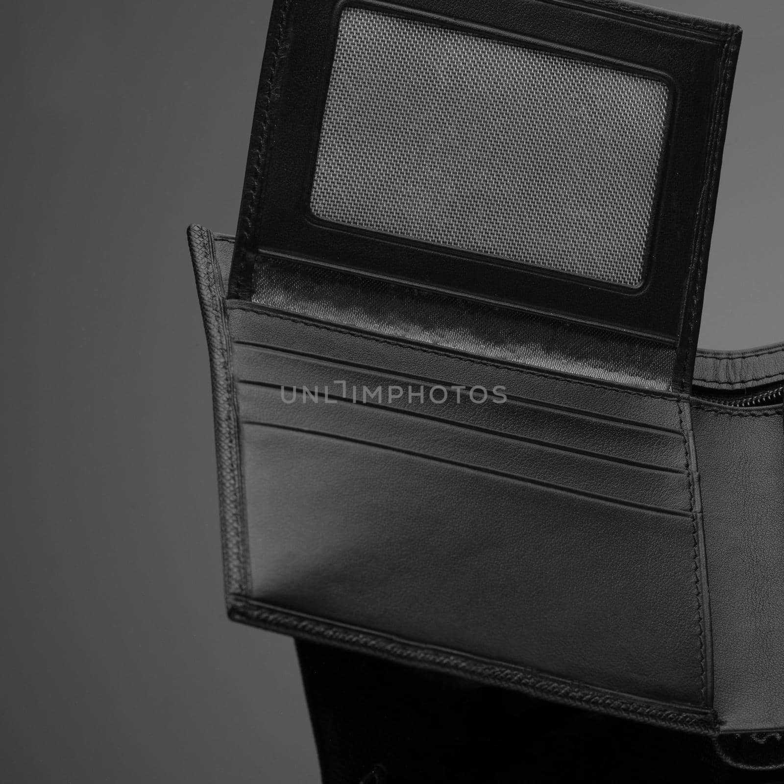 A closeup of a fashionable leather wallet on a dark background