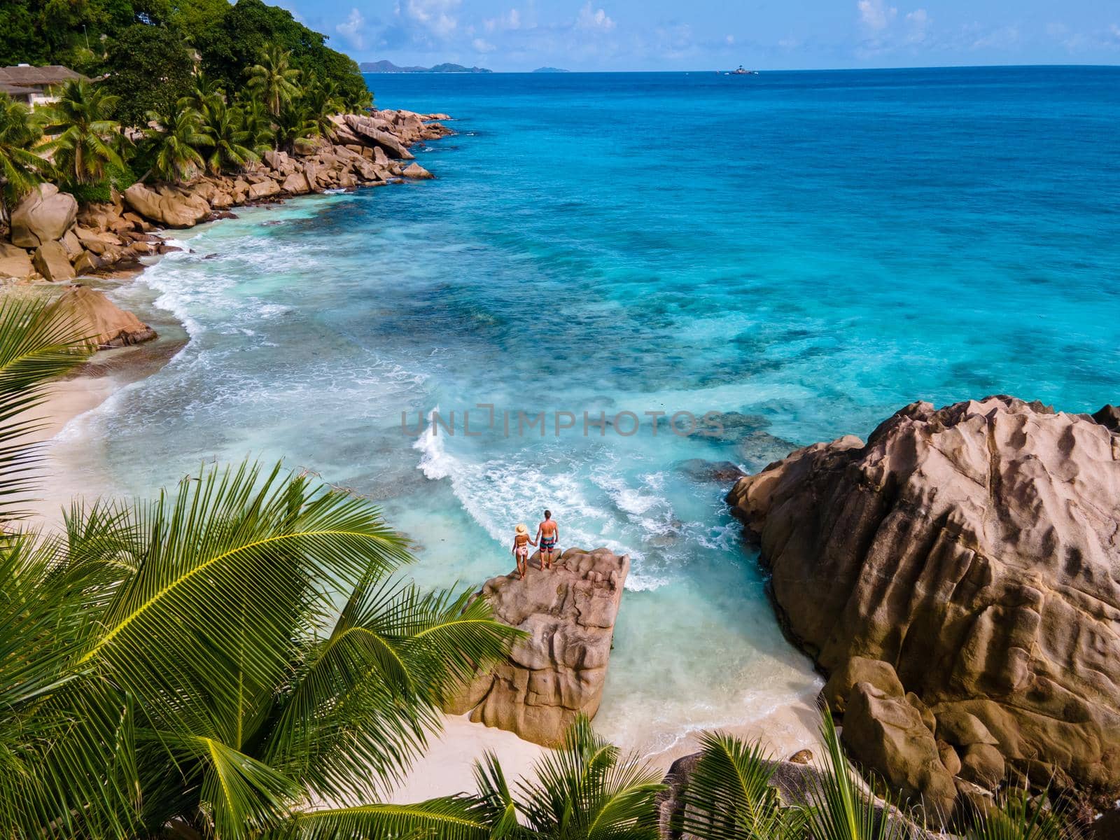 Anse Patates beach, La Digue Island, Seyshelles, Drone aerial view of La Digue Seychelles bird eye view.of tropical Island. mature couple men and women on vacation in Seychelles