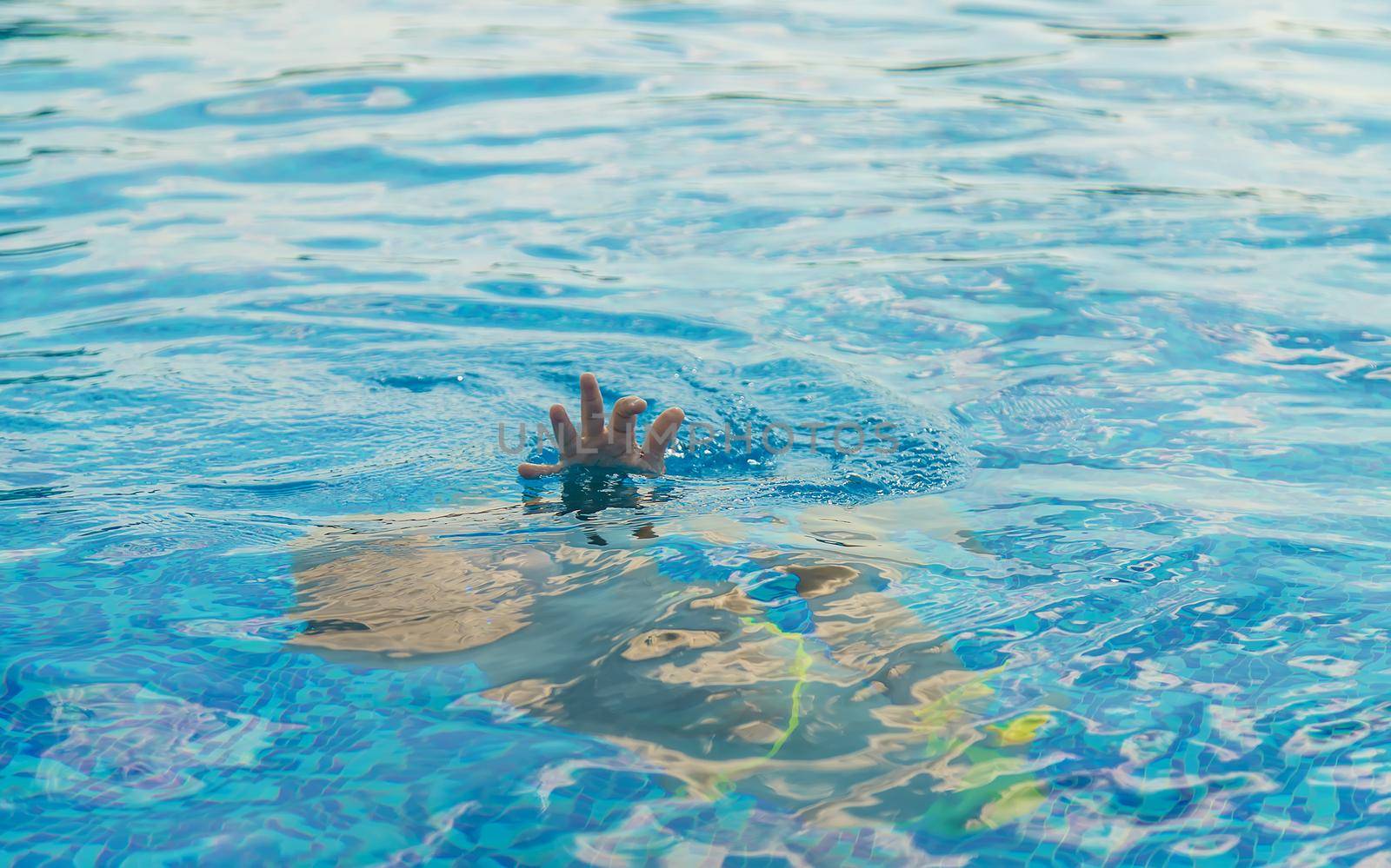 The child is drowning in water. Selective focus. Kid.