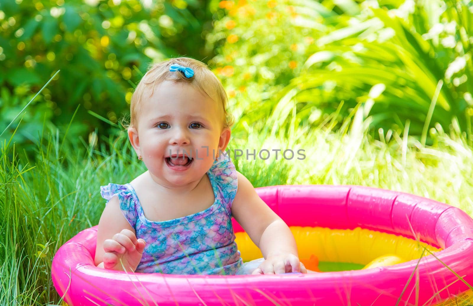 Baby swims in the pool. Selective focus. Child.