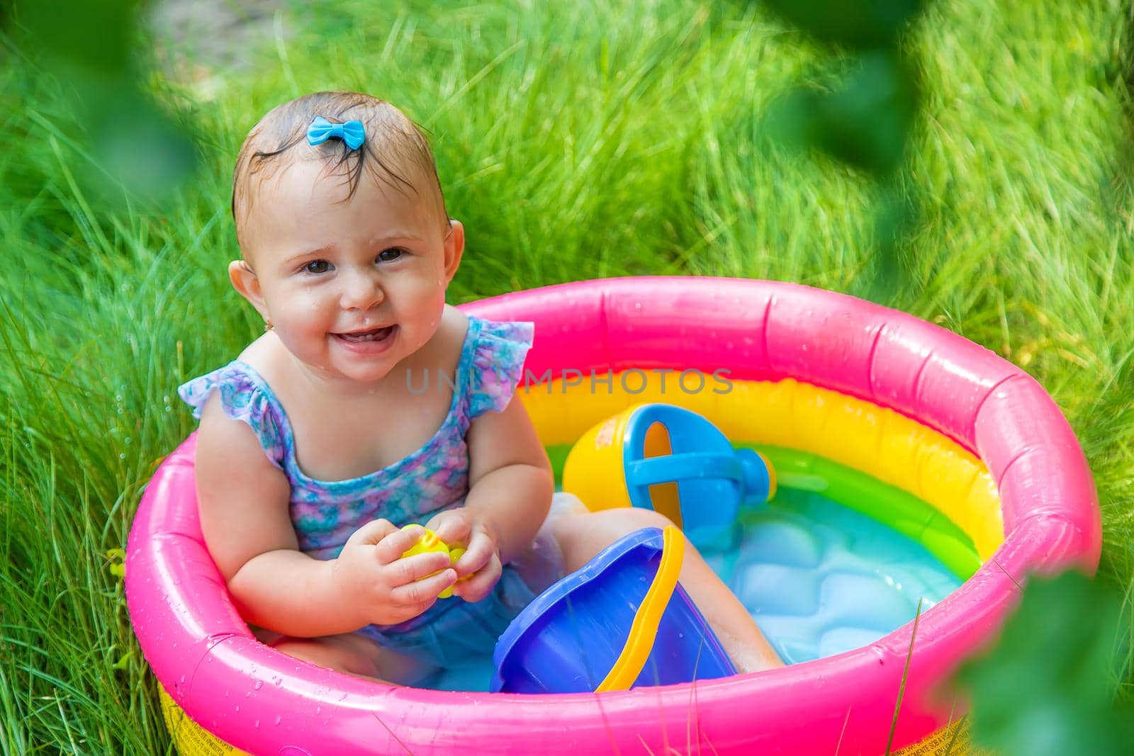 Baby swims in the pool. Selective focus. Child.