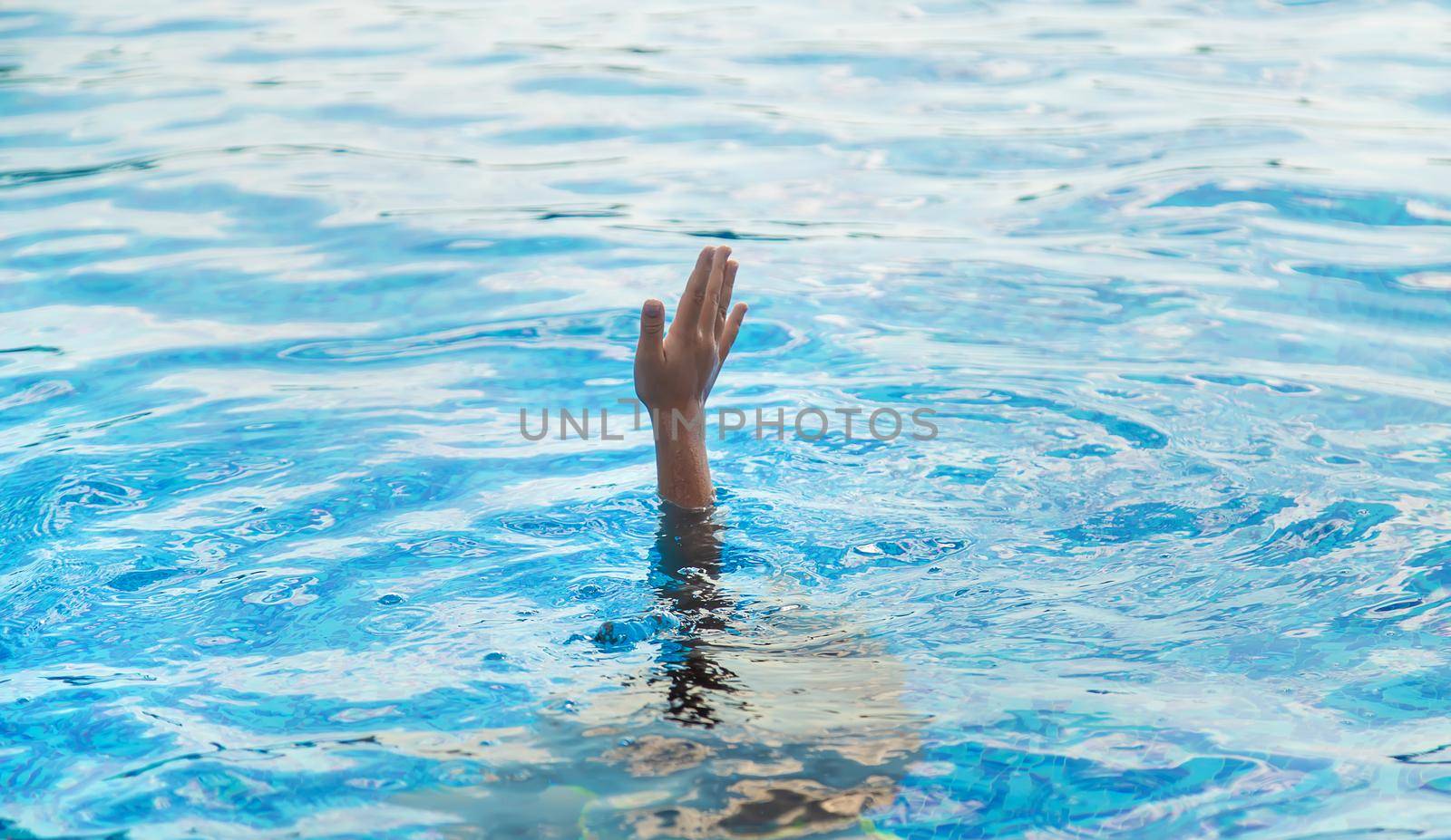 The child is drowning in water. Selective focus. Kid.