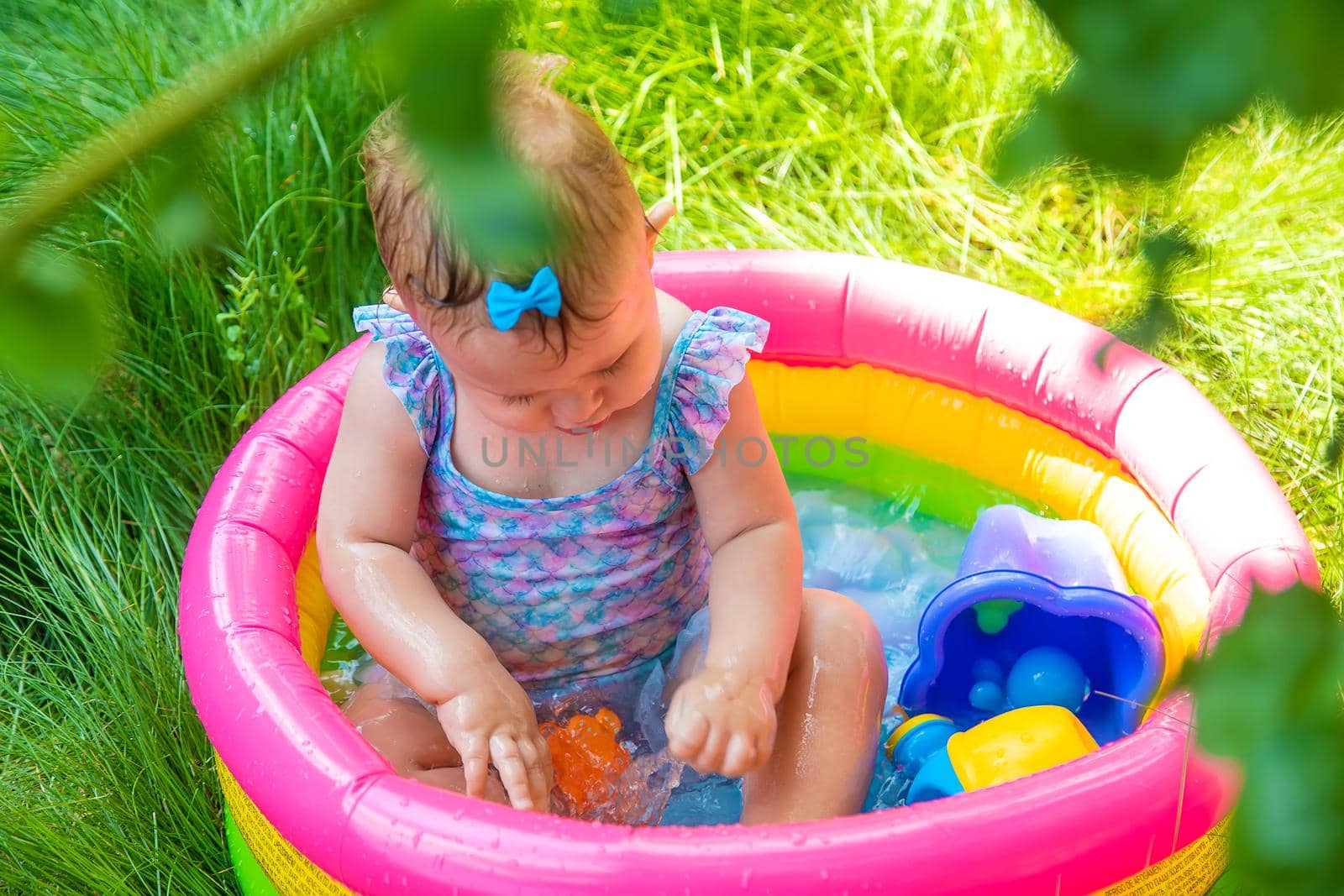 Baby swims in the pool. Selective focus. Child.