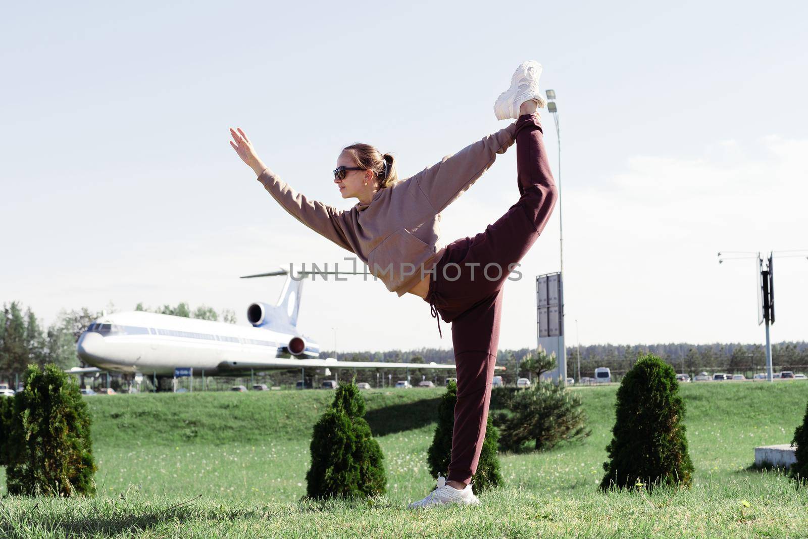 happy young woman posing as a plane . by SmartPhotoLab