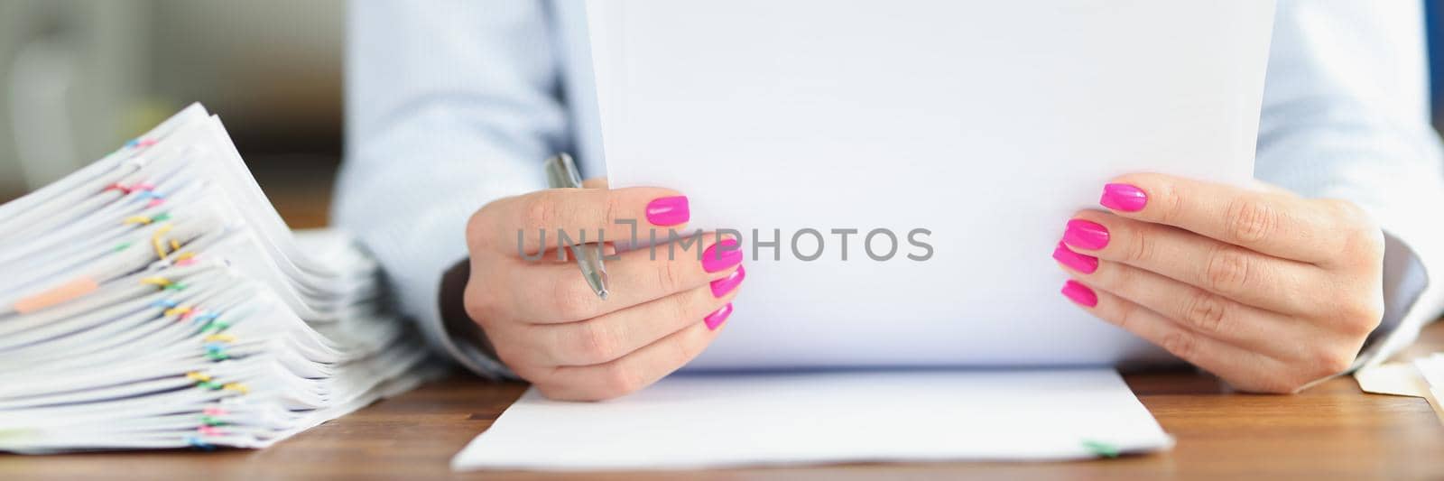 Close-up of businesswoman reading new candidate application for work in company. Stack of peoples cv wishing to get job position. Hr department concept