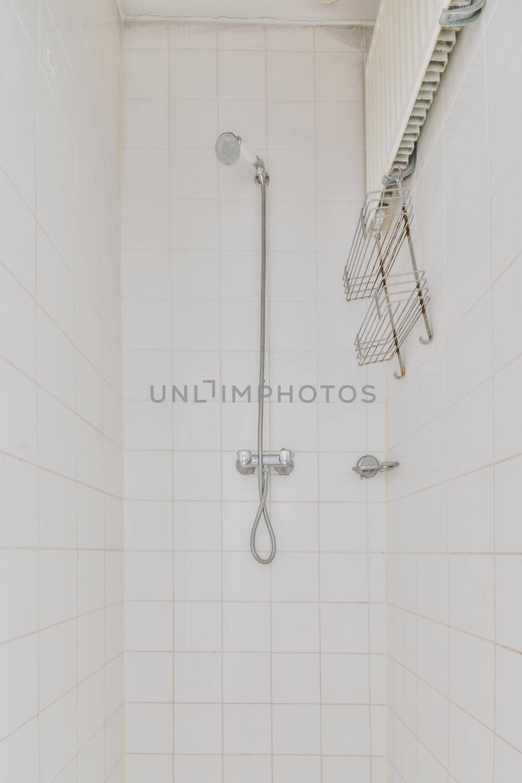 Interior of narrow bathroom and toilet with showroom, sink and wall hung toilet with white walls and checkered floor