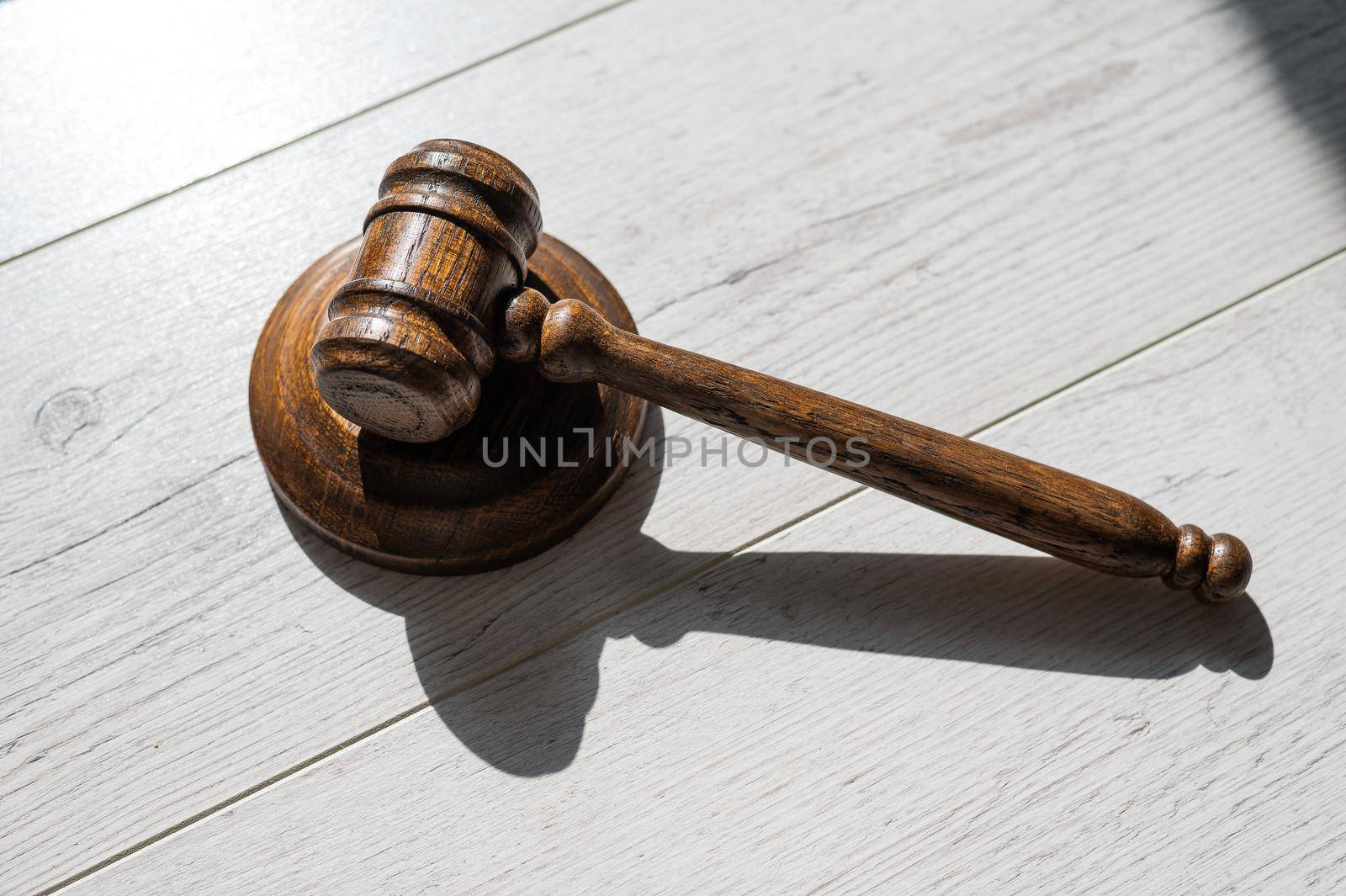 Wooden judicial gavel on a wooden laminate