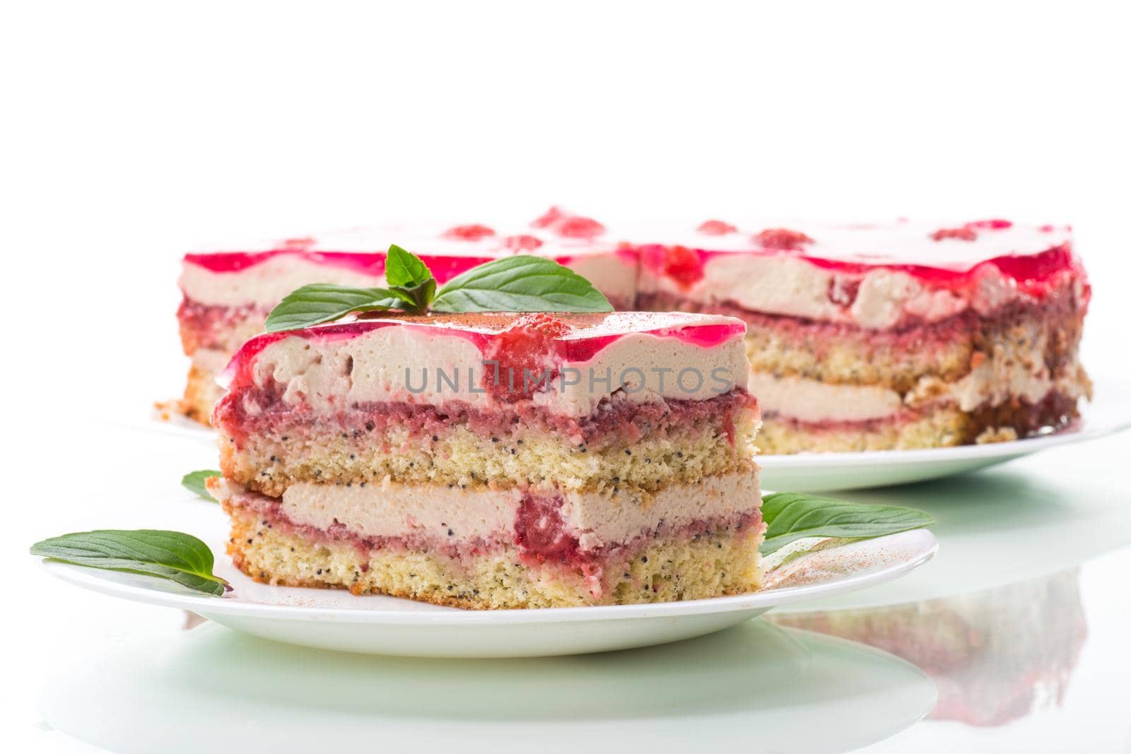 strawberry poppy cake with cream in a plate isolated on white background