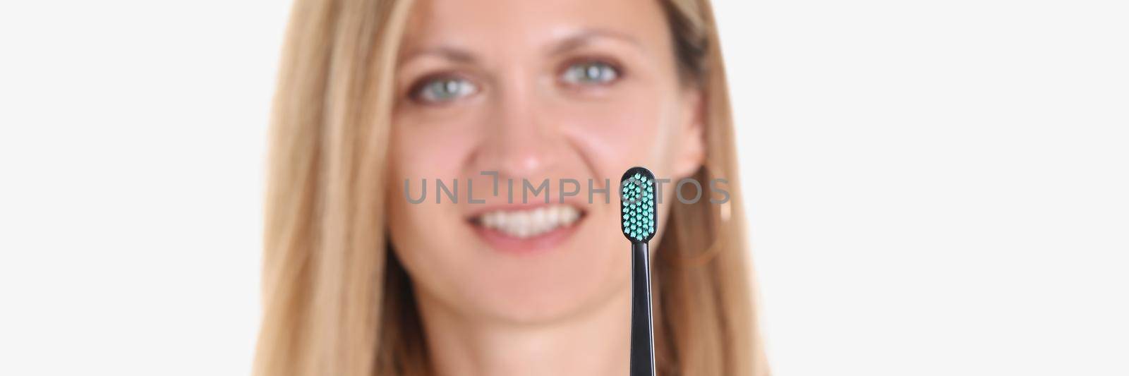 Happy smiling woman take care of teeth and show toothbrush by kuprevich