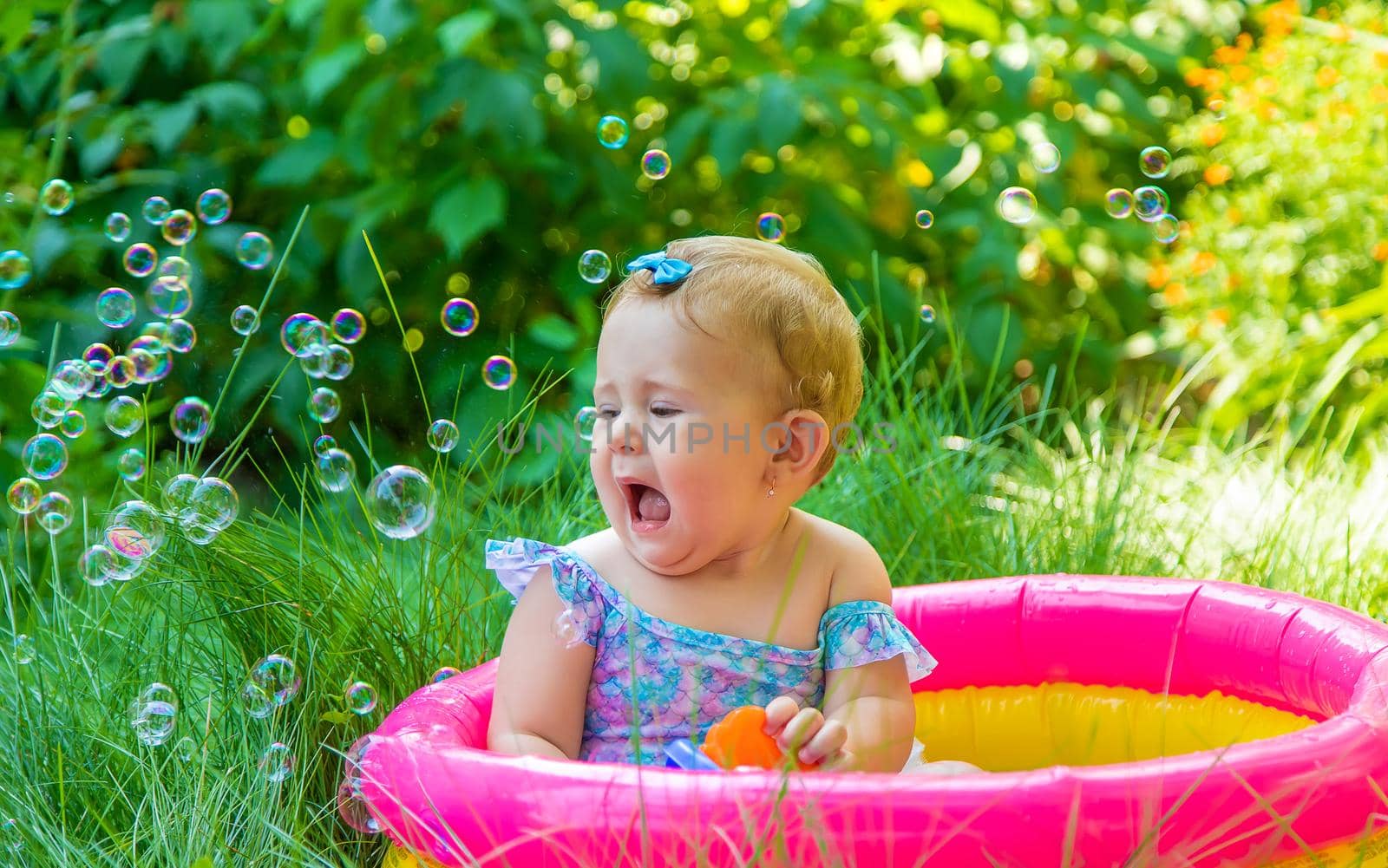 Baby swims in the pool. Selective focus. Child.