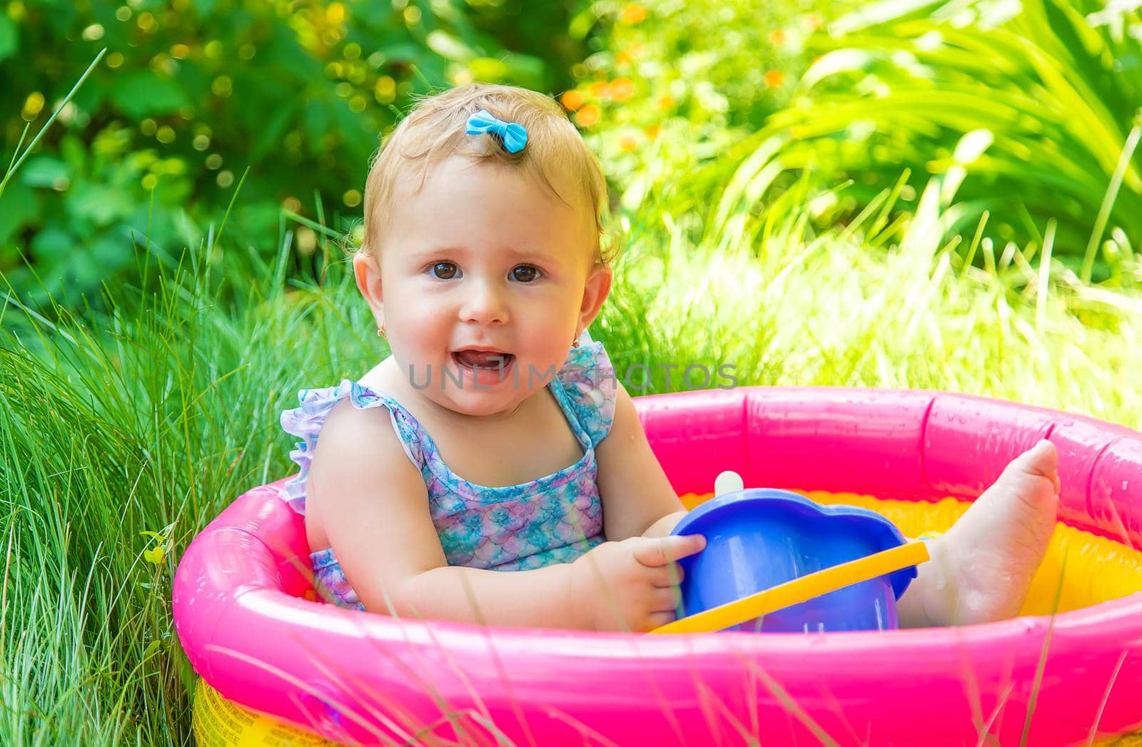 Baby swims in the pool. Selective focus. Child.