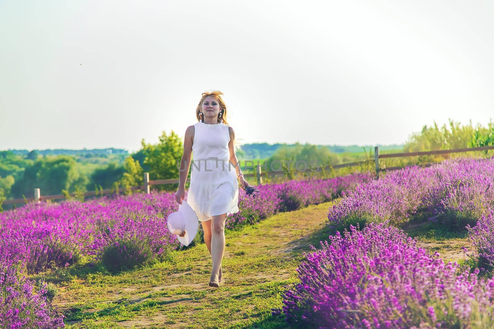 Woman in summer lavender field. Selective focus. Nature.