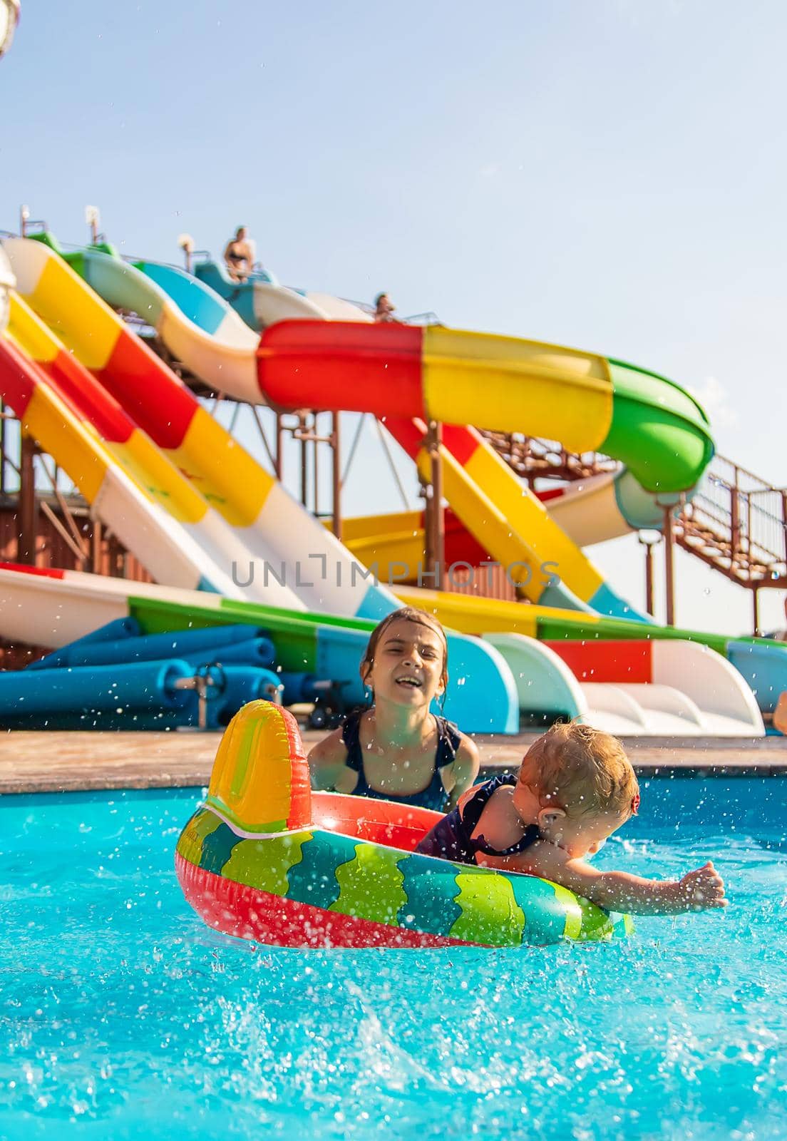 Baby swims in a circle in the pool. Selective focus. by yanadjana