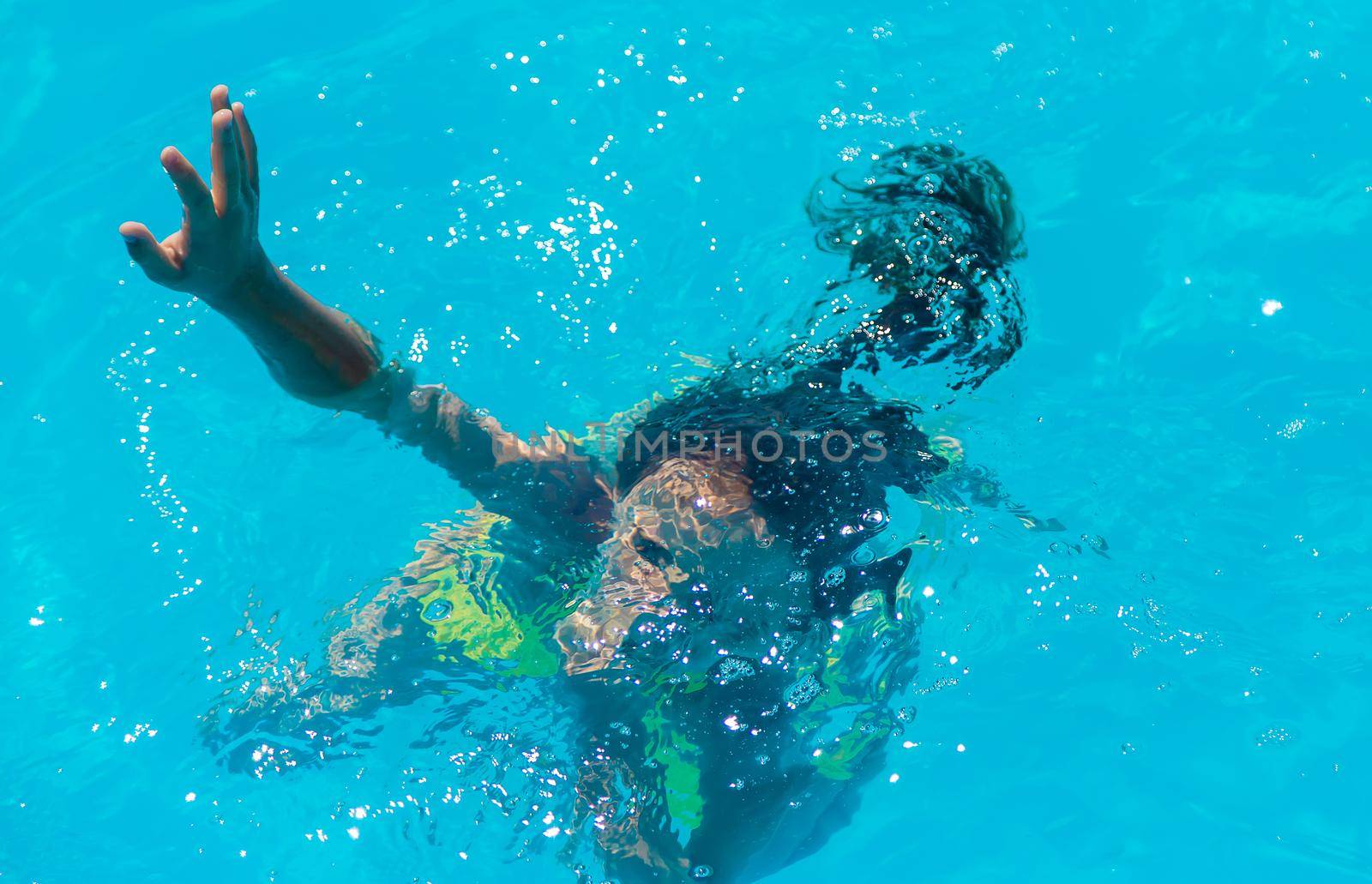 The child is drowning in water. Selective focus. Kid.