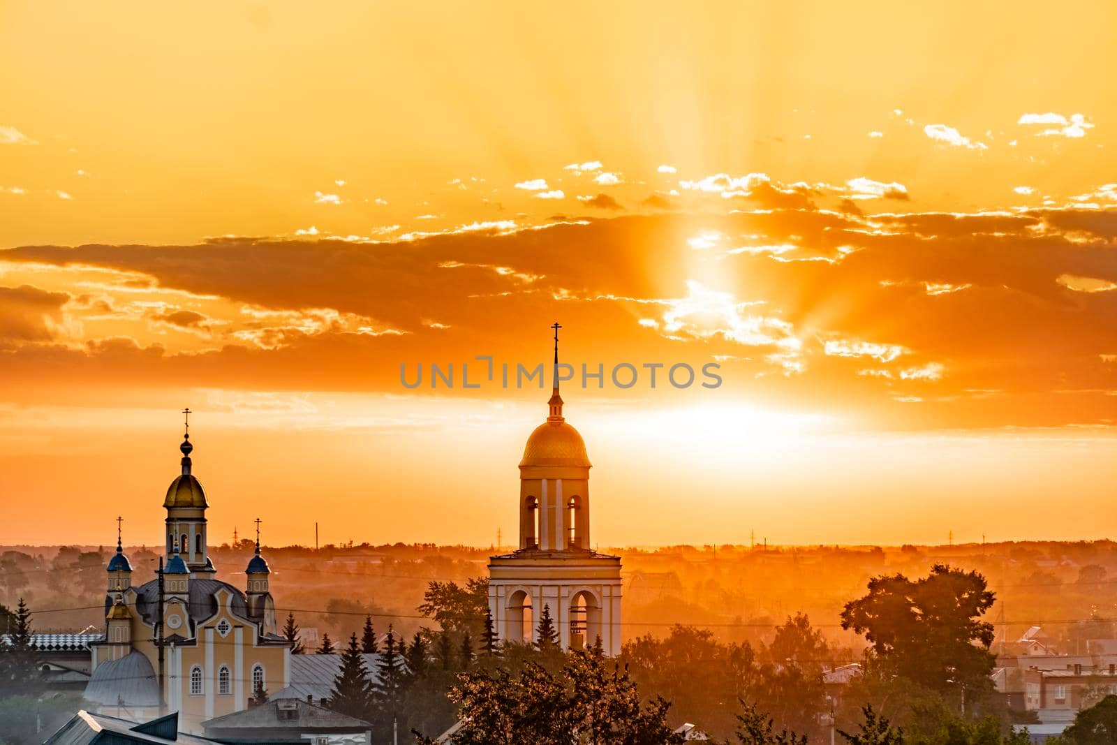 Golden domes with Orthodox crosses on the church.Temple or cathedral on the background of an evening sunset with a golden sky. A lonely church at dusk with sunset clouds.Golden Hour,skyline,horizon by YevgeniySam