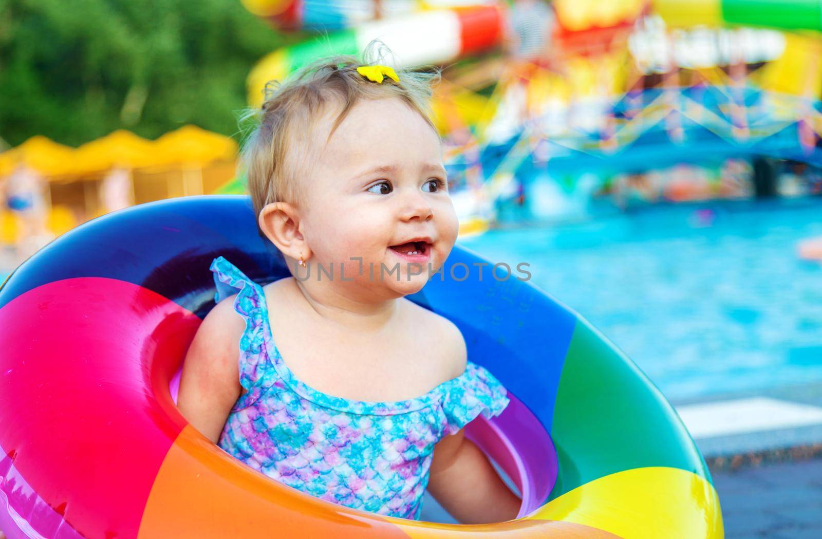 Baby with a circle near the pool. Selective focus. by yanadjana