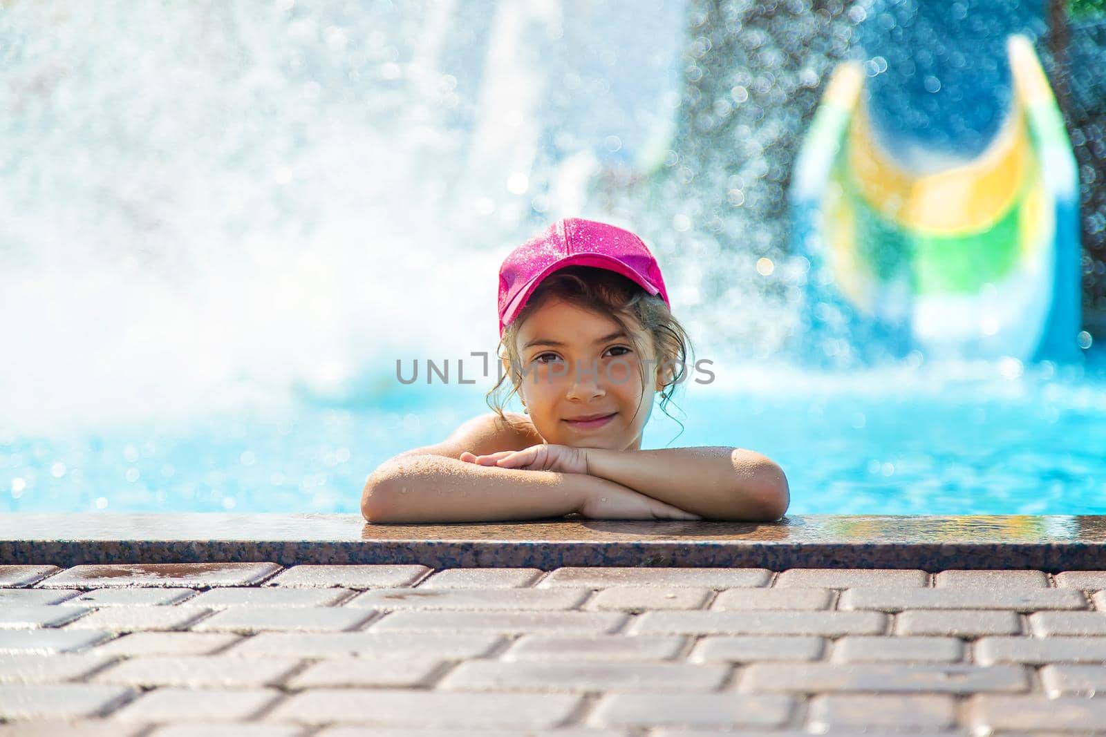 The child swims in the water park. Selective focus. Kid.
