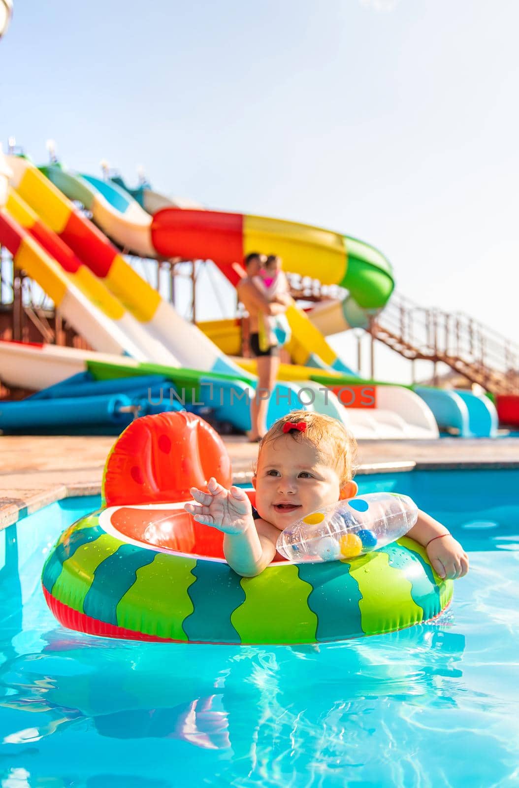 Baby swims in a circle in the pool. Selective focus. Nature.