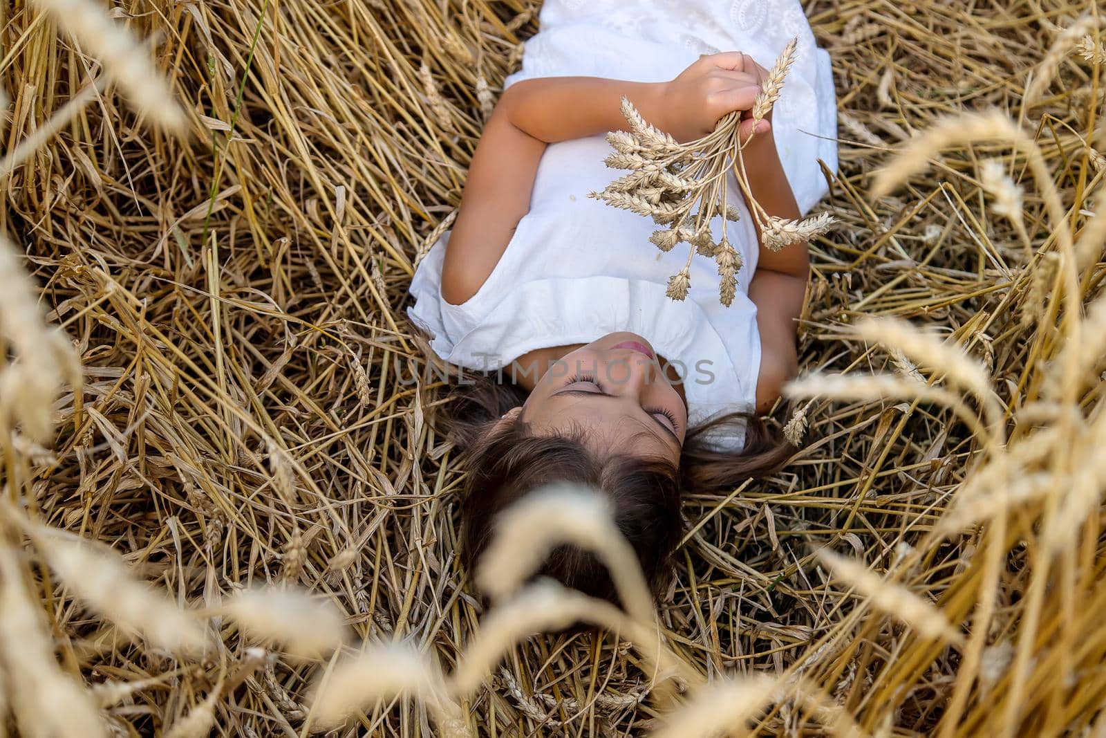A child in a wheat field. Selective focus. Nature.