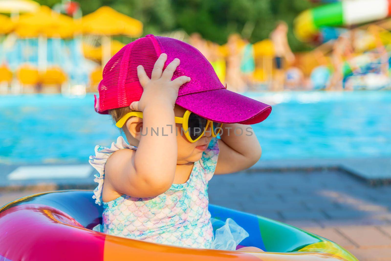 Baby with a circle near the pool. Selective focus. by yanadjana