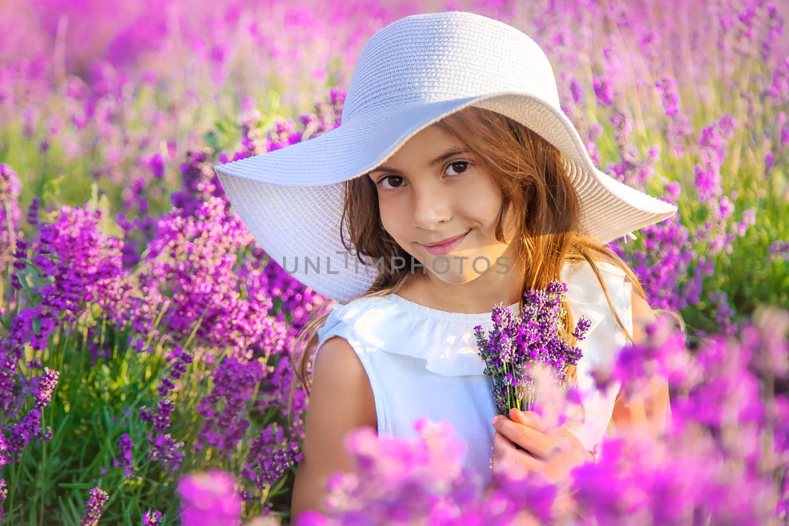 A child in a lavender field. Selective focus. Nature.