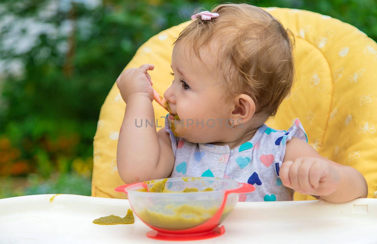 Baby is eating vegetable puree. Selective focus. Child.