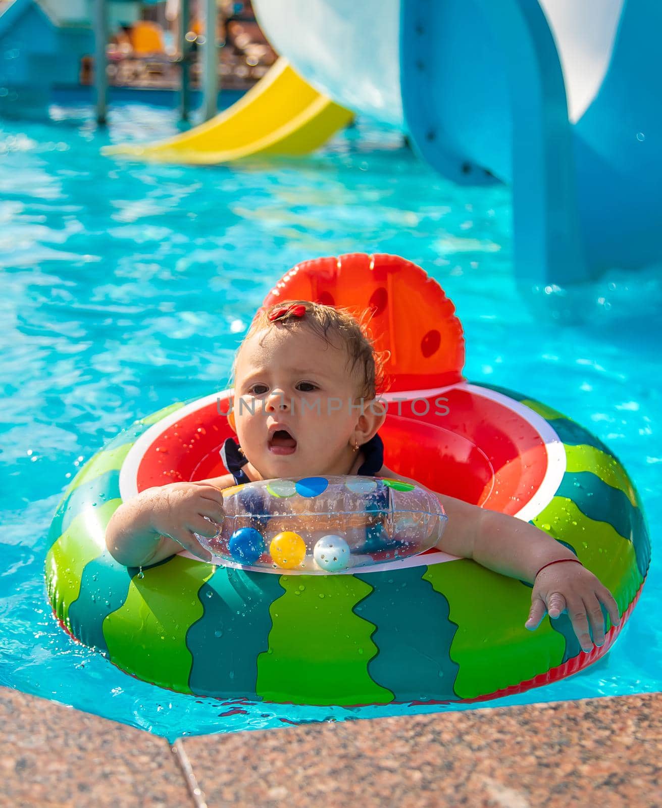 Baby swims in a circle in the pool. Selective focus. Nature.