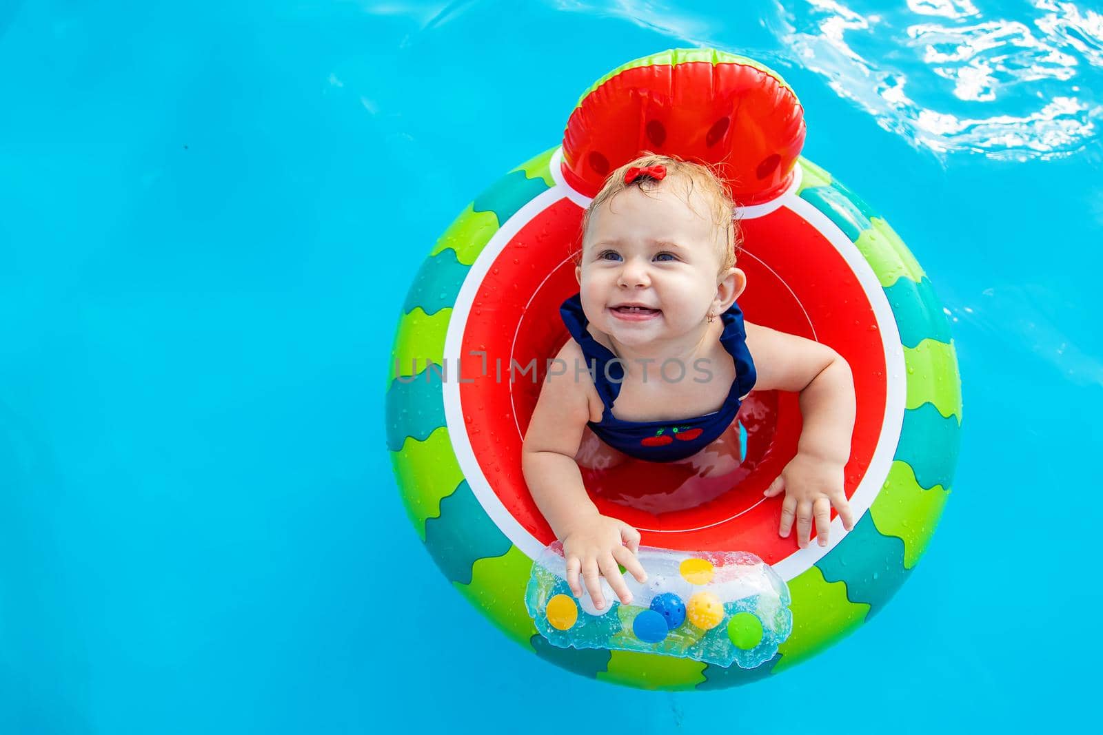 Baby swims in a circle in the pool. Selective focus. Nature.