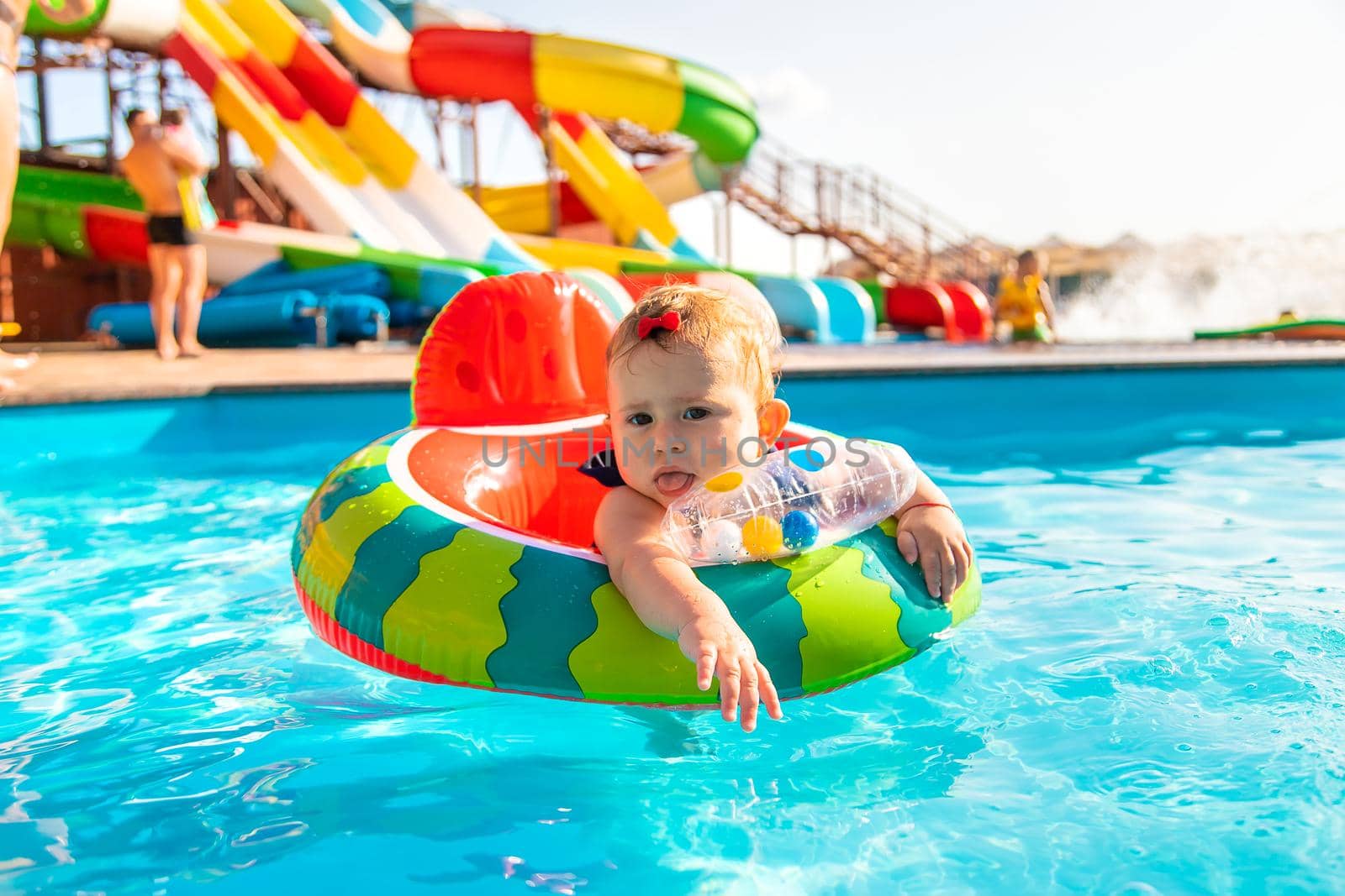 Baby swims in a circle in the pool. Selective focus. Nature.