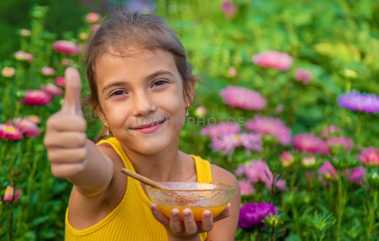 The child eats flower honey. Selective focus. by yanadjana