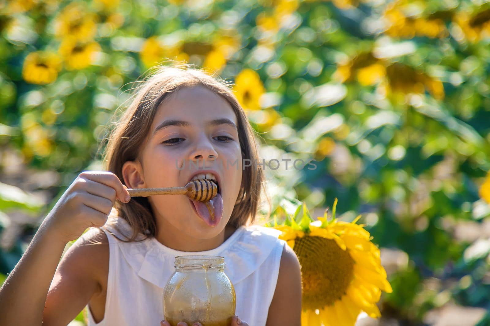 The child eats flower honey. Selective focus. Nature.