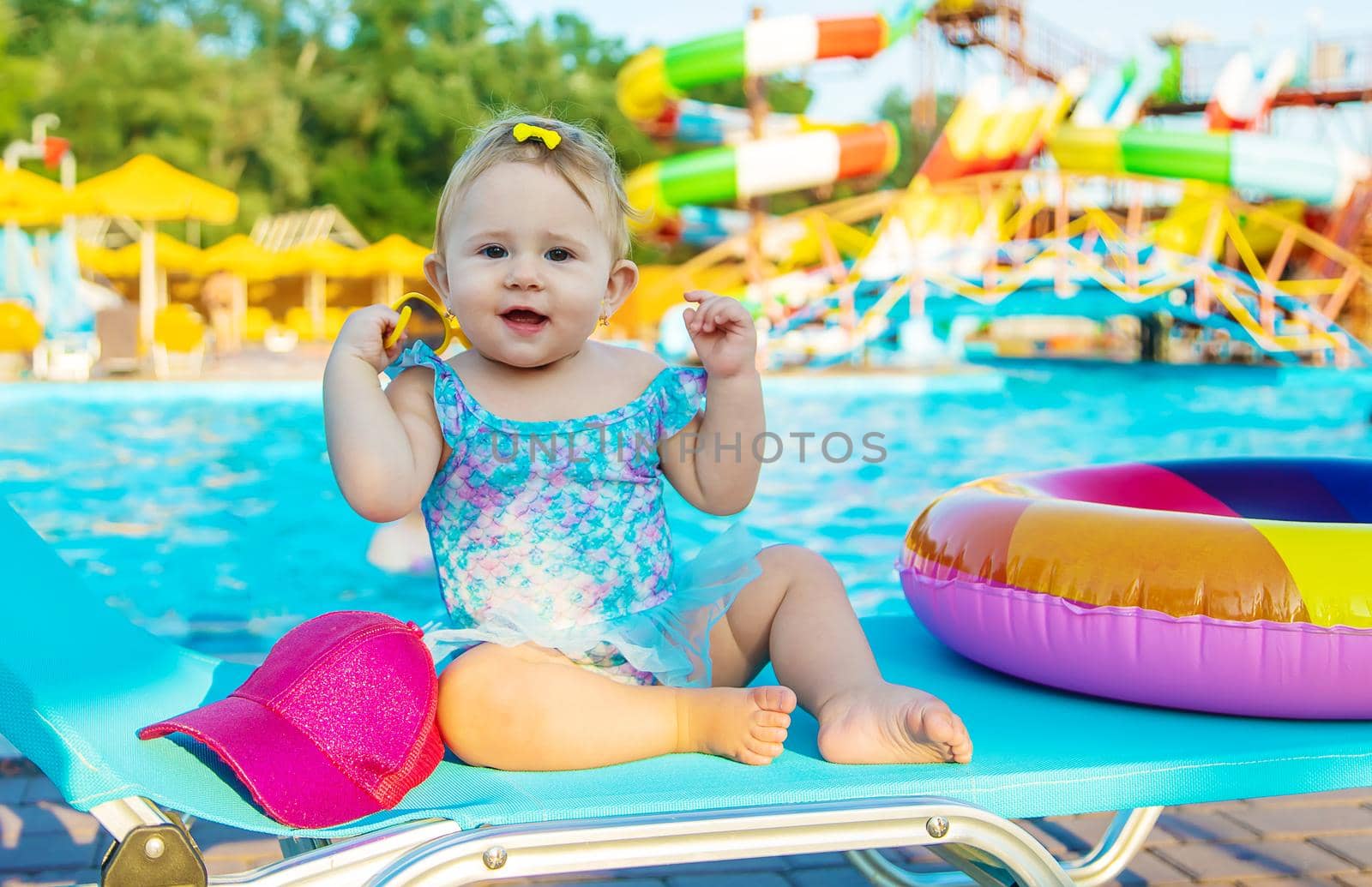 Baby is sitting by the pool. Selective focus. Child.
