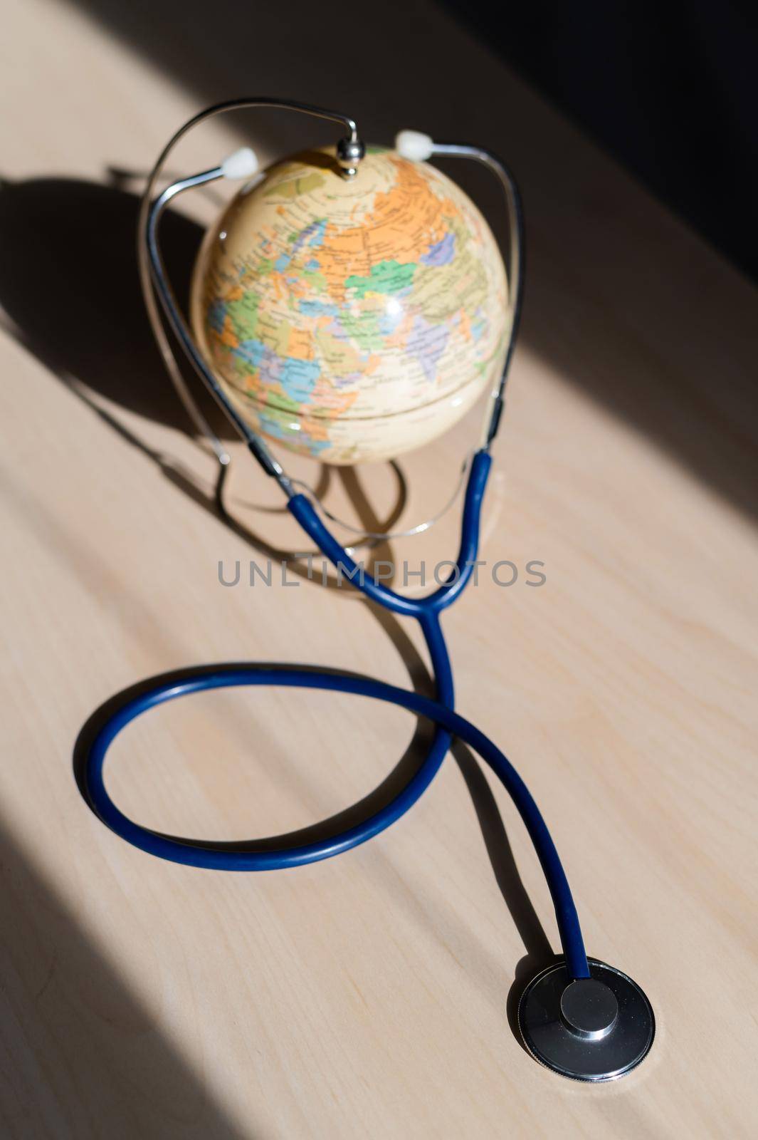 Globe and phonendoscope on the table