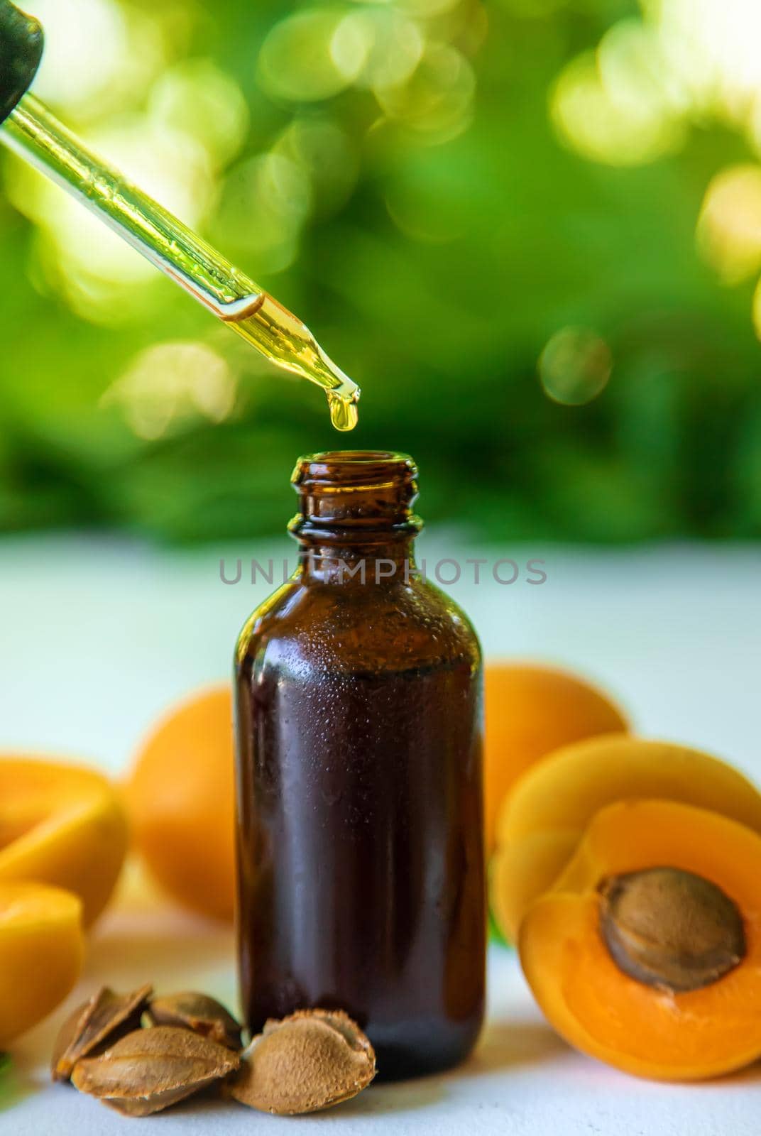 Apricot kernel oil in a bottle. Selective focus. Food.