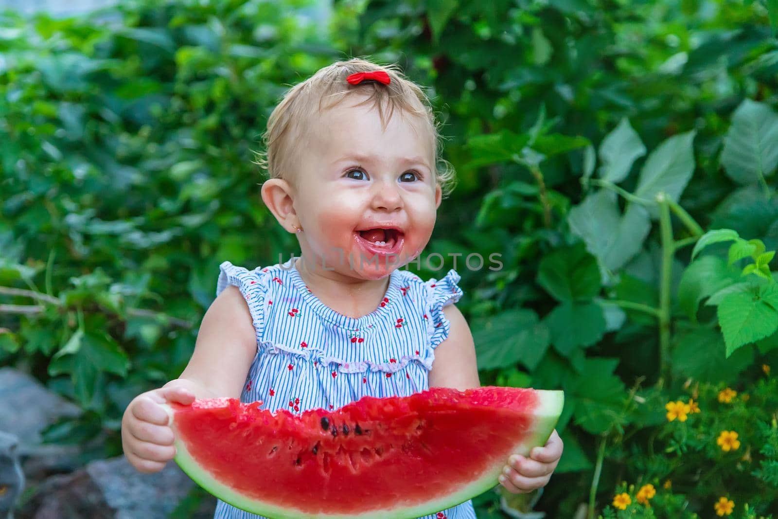 Baby eats watermelon in summer. Selective focus. by yanadjana