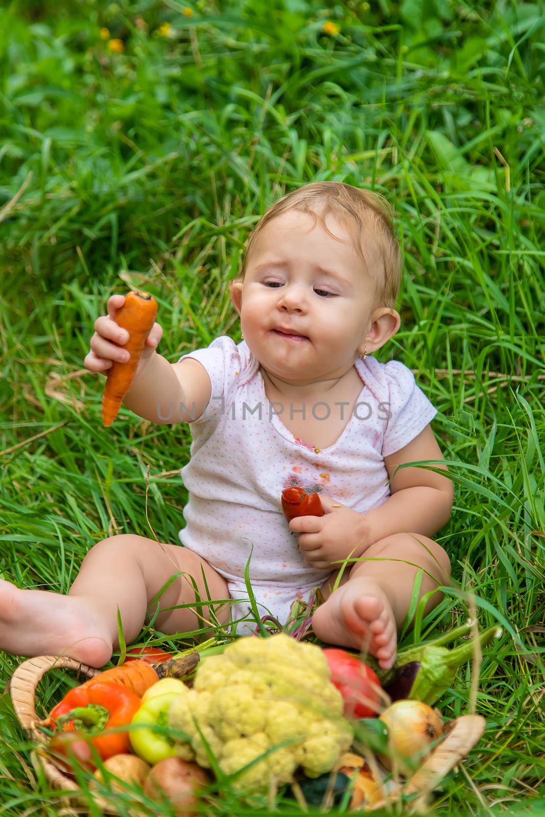 The child holds vegetables in his hands. Selective focus. Kid.
