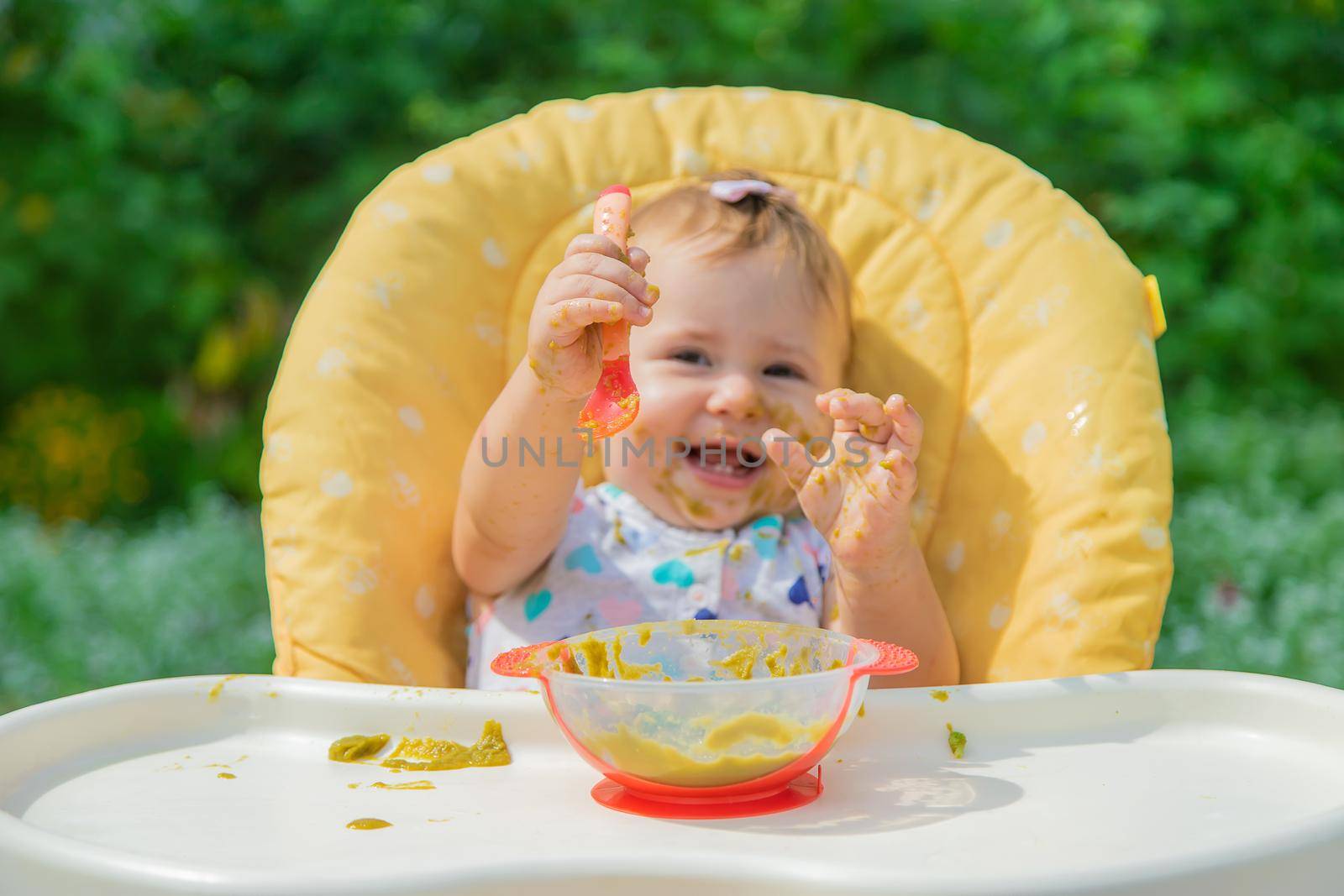 Baby is eating vegetable puree. Selective focus. Child.