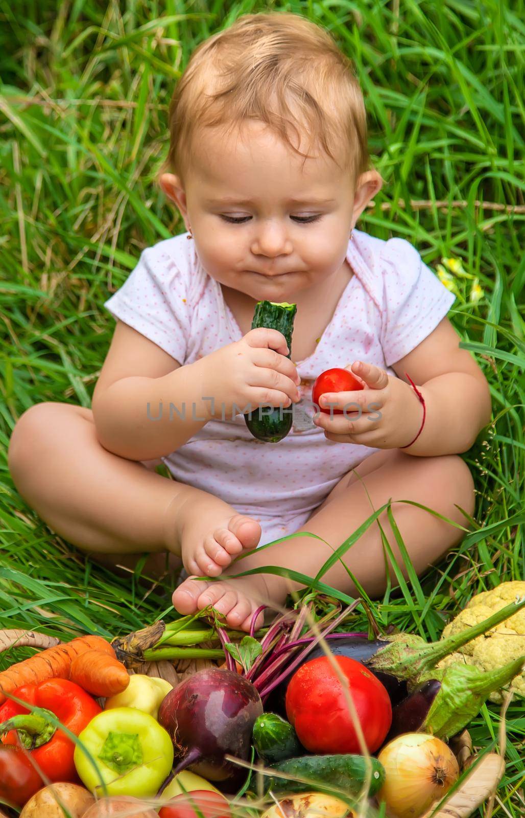 The child holds vegetables in his hands. Selective focus. Kid.