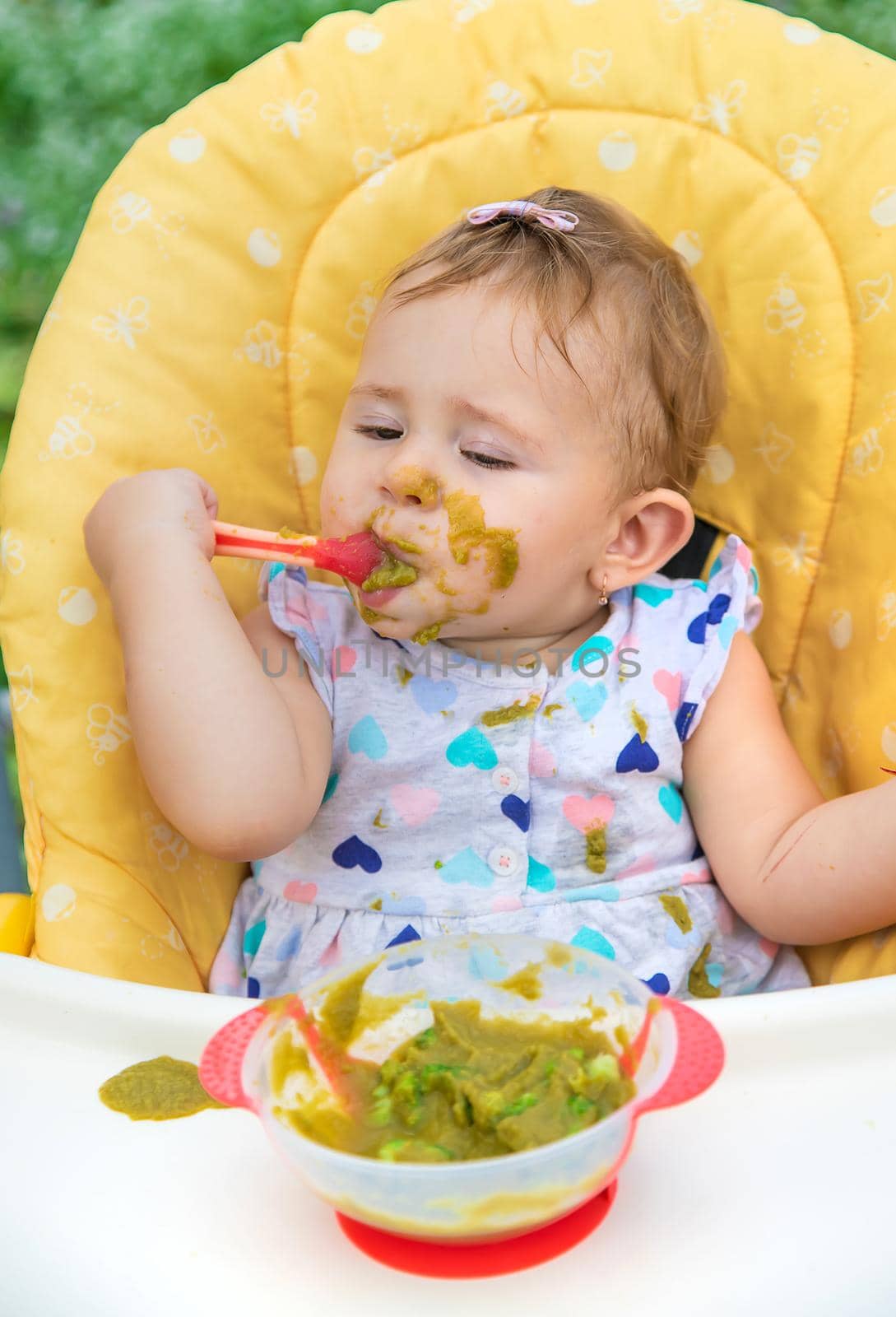 Baby is eating vegetable puree. Selective focus. Child.
