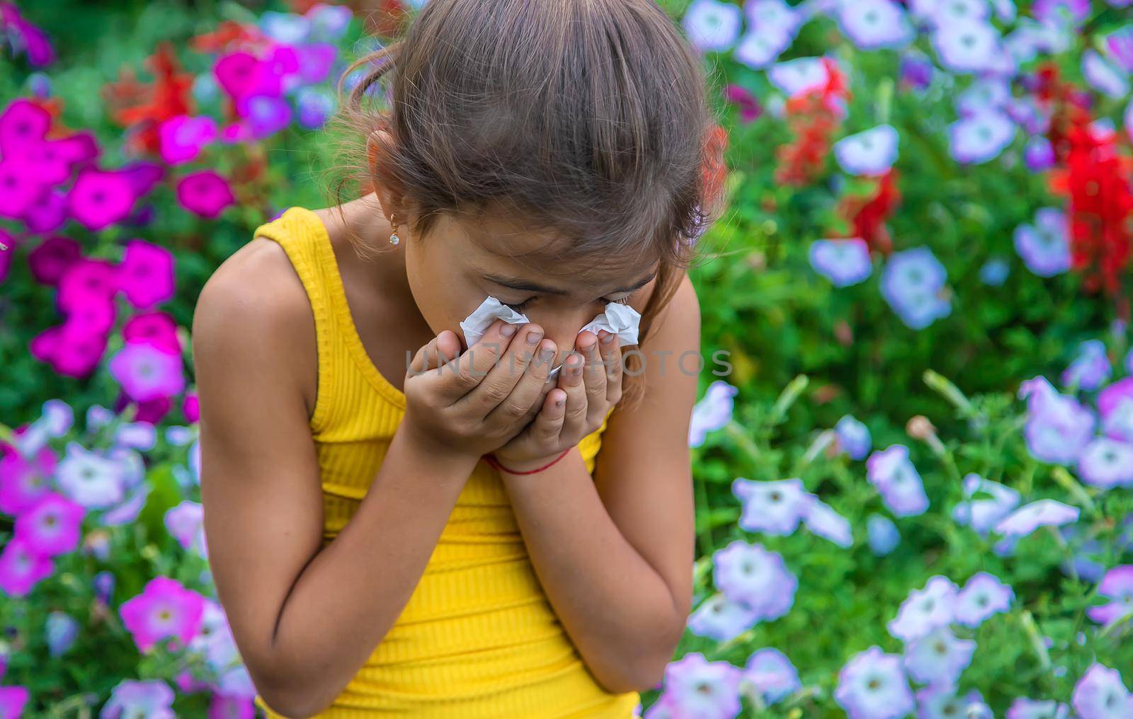 The child is seasonal allergy to flowers. Selective focus. Kid.