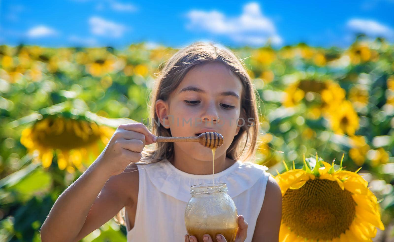 The child eats flower honey. Selective focus. Nature.