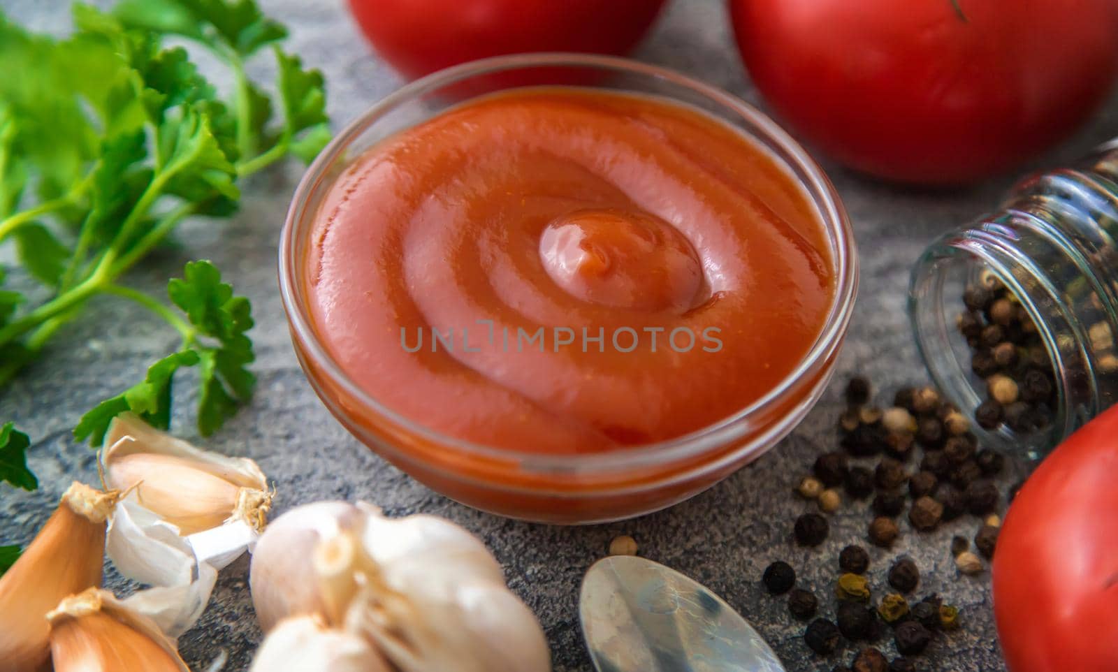 Ketchup in a bowl on the table. Selective focus. Food.